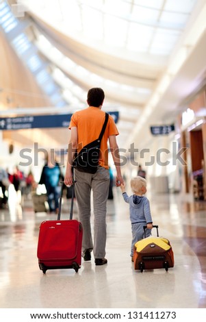 father and son with the luggage at the airport