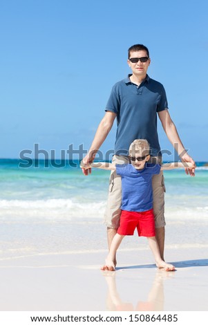 happy family of two spending time together at the perfect caribbean beach