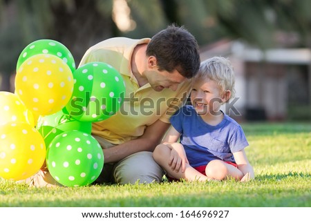 happy family of two with colorful balloons