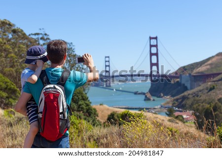 happy father and son taking picture of golden gate bridge in san francisco, travel and technology concept