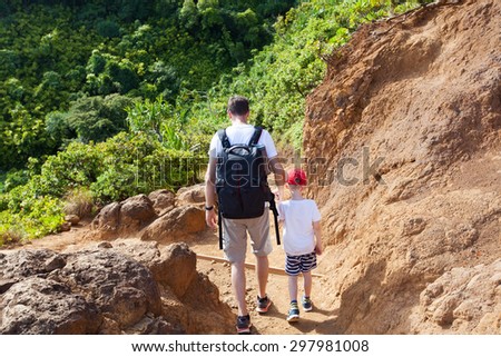 family of two hiking together the kalalau trail at kauai island, hawaii