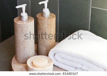 bath dispensers, soap and white towel on the tray