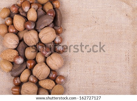 Variety of mixed nuts on brown hessian
