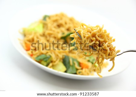picture of fried noodles with vegetables on white background.