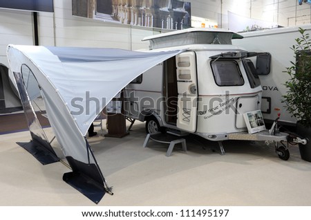 DUSSELDORF - AUGUST 27: Hymer Touring mobile home with elevating roof at the Caravan Salon Exhibition 2012 on August 27, 2012 in Dusseldorf, Germany