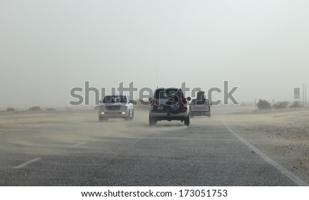DOHA, QATAR - DEC 15: Desert highway in Qatar during sandstorm. December 17, 2013 in Doha, Qatar, Middle East