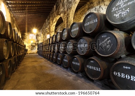 EL PUERTO DE SANTA MARIA, SPAIN - JULY 16: Wine Barrels in cellar of the famous Osborne Sherry Bodega. 16th July 2012 in El Puerto de Santa Maria, Andalusia Spain