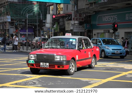 HONG KONG - NOV 27: Typical Hong Kong taxi - a red Toyota Crown Comfort downtown in a city street. November 27, 2010 in Hong Kong, China