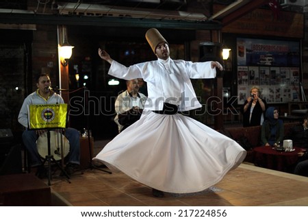 ISTANBUL, TURKEY - MAY 22: Whirling Dervish dancing  in a side walk cafe in Istanbul. May 22, 2011 in Istanbul, Turkey