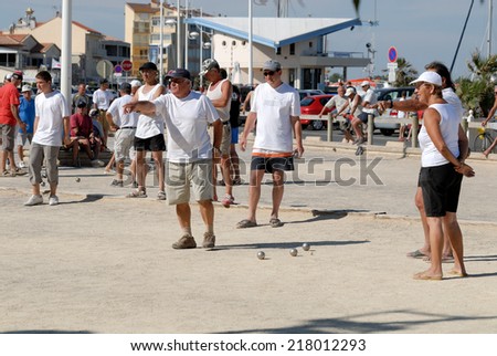 SAINT-CYPRIEN, FRANCE - JULY 17: Retired French men playing bowl on the promenade. July 17, 2008 in Saint-Cyprien, Pyrenees-Orientales, France
