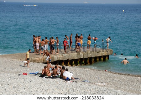 NICE, FRANCE - JULY 2: Young people having fun on the mediterranean beach. July 2, 2008 in Nice, Provence-Alpes-Cote d\'Azur, France