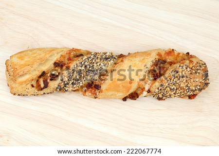 Traditional german cheese pretzel stick with sesame and poppy seeds