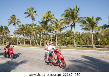 KEY WEST, USA - NOV 19: Tourists on scooters in Key West. November 19, 2009 in Key West, Florida, USA