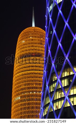 DOHA, QATAR - JAN 9: Burj Qatar and the blue illuminated QIPCO Tower in Doha. January 9, 2012 in Doha, Qatar, Middle East