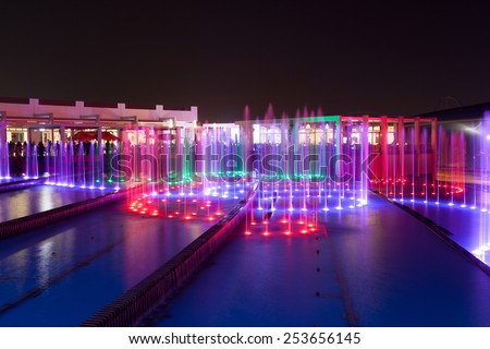 ABU DHABI - DEC 19: Fountain at the Ferrari World Theme Park illuminated at night. December 19, 2014 at the Yas Island in Abu Dhabi, UAE