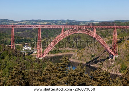 Historic iron railway arch bridge - The Garabit Viaduct - through the River Truyere was built 1884 by the famous french engineer Gustave Eiffel