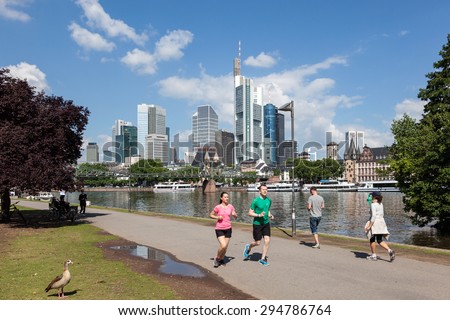 FRANKFURT MAIN - JUNE 28: People jogging at the riverwalk park in the city of Frankfurt am Main. June 28, 2015 in Frankfurt Main, Germany