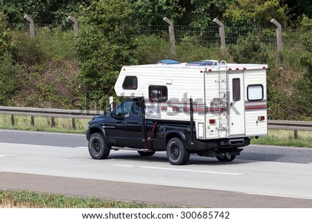 FRANKFURT, GERMANY - JULY 26: Dodge RAM 2500 pickup truck with a Fleetwood Elkhorn camper cabin moving fast on the highway A5. July 26, 2015 in Frankfurt Main, Germany