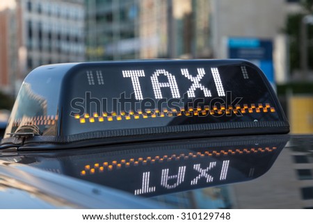 Illuminated sign of a black cab in the city of Brussels, Belgium