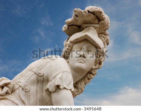 Statue of a roman warrior against blue sky