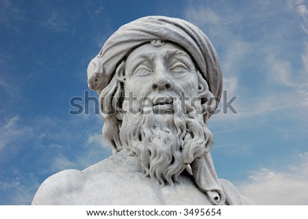 Ancient roman statue against blue sky