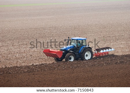 stock photo : Tractor plowing the field