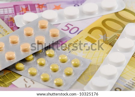 Pills on European currency. Concept of medicating an injured economy, or concept of the cost of medication