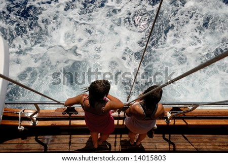 Young women standing on the deck of a ship
