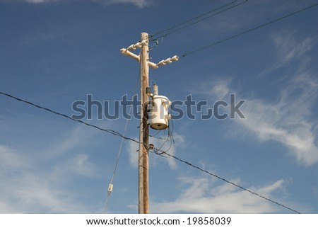 Transformer on wooden pole with wiring and insolators