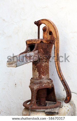 Antique rusty water pump in Faro, Portugal