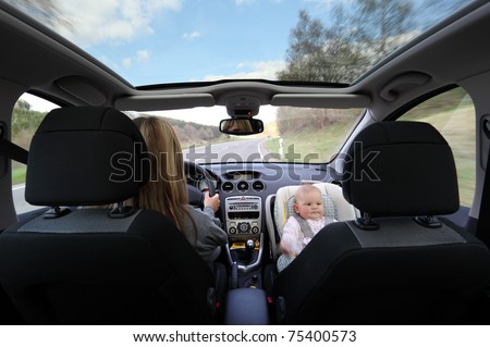Mother driving car with her baby