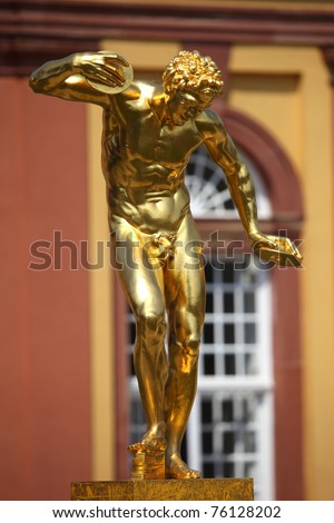 Golden replica of ancient greek statue showing a disc thrower athlete