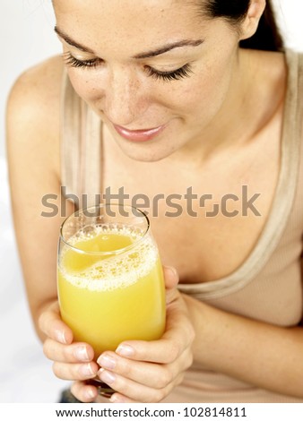 Young Woman Holding a Glass of Pineapple Juice
