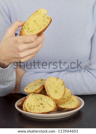 Young Woman Eating Garlic Bread
