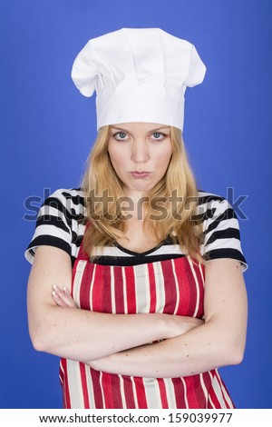 Model Released. Angry Young Woman in Chefs Hat and Apron