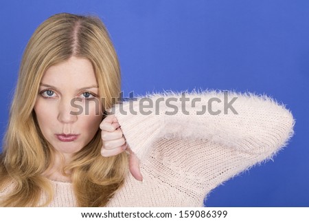 Model Released. Attractive Sad Young Woman Thumbs Down
