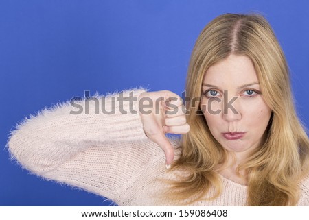 Model Released. Attractive Sad Young Woman Thumbs Down