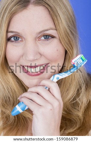 Model Released. Happy Young Woman Brushing Teeth
