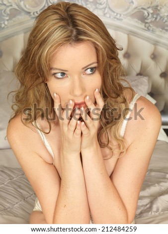 Sexy Frightened Young Woman Model Posing on a Bed