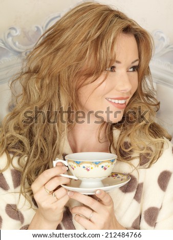 Attractive Young Woman Having Tea In Bed