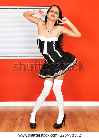 Sexy Young Woman in a Short French Maids Outfit