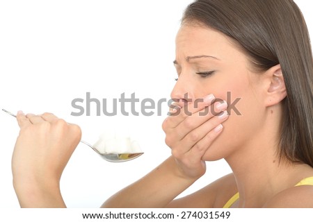 Attractive Young Woman in Her Twenties Holding a Spoonful of Sugar
