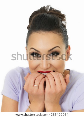Portrait Of A Beautiful Young Nervous Hispanic Woman Biting Her Nails In Fear Against A White Background