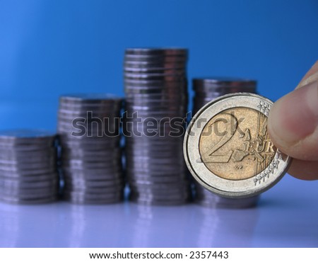 Coin piles with euro coin in closeup.