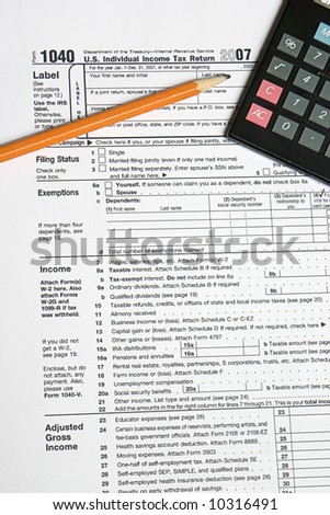 Tax form pencil and calculator for tax time