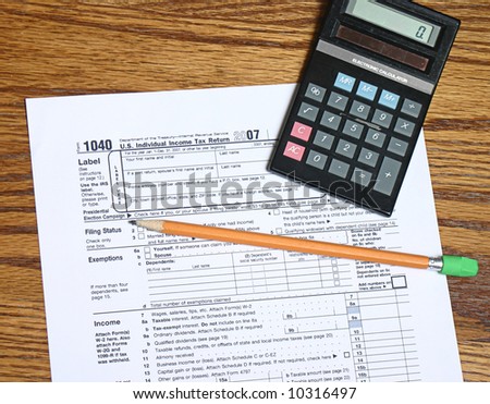 Tax form pencil and calculator for tax time