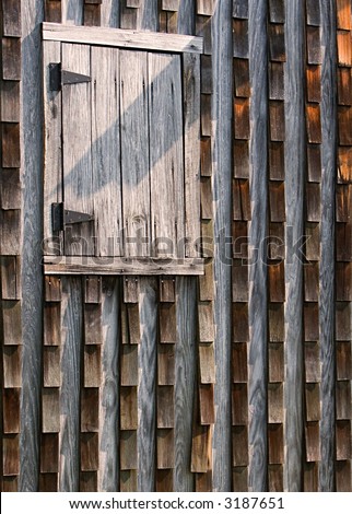 An Old Wood Shingled Wall With Closed Wood Window