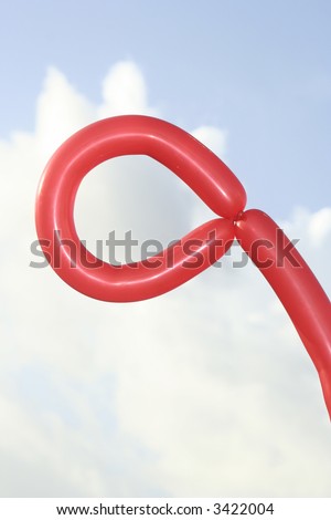 Balloon folded in a loop with the sky as a backdrop