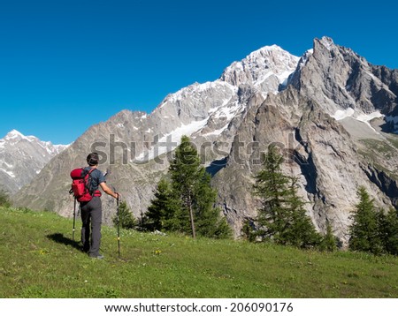 Hiker admiring mountain landscape around Mont Blanc, Courmayer, Italy, Europe.