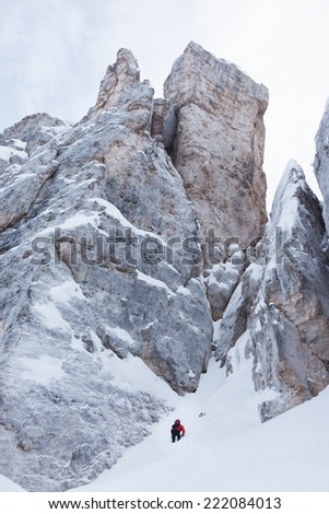 Mountaineer on the snowy steep north face of Torri di Falzarego peak - Cortina d\'Ampezzo, Dolomiti, Italy, Europe.